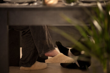 With cozy slippers at the dining table