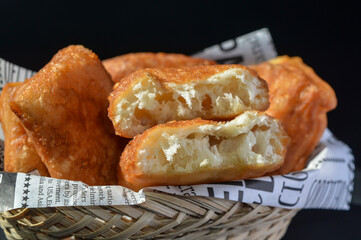 Odading or cube-shaped fried bread with a brown crispy outer skin and sprinkled with sesame seeds, the inside is empty and expands, so that it looks like a small pillow.