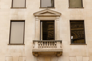 Fototapeta na wymiar Facade of a London building with a marble stone balcony. ​London, Great Britain 08.14.2023