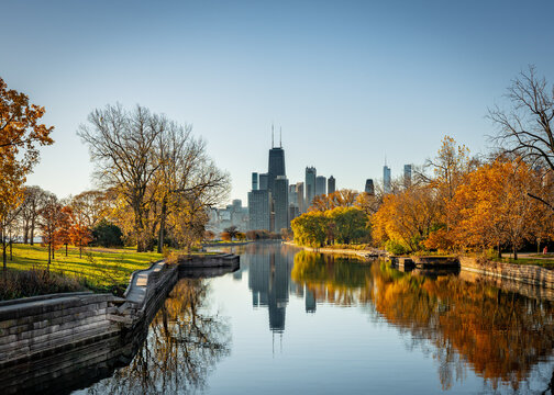 Chicago skyline seen from the north at dawn in Autumn with canal 