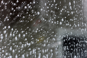 White cleaning foam on glass