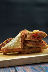 Martabak Tahu or Tofu Martabak, filled with bits of vegetables, leek, red chili, sausage, tofu and egg. Indonesian street food.