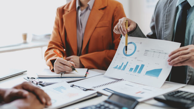 Teamwork process, business people working in the office discussing documents and ideas at meeting.