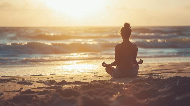 woman meditating on a beach at sunrise