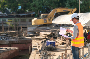 Construction engineer working on a bridge construction site over a river,Civil engineer supervising work,Foreman inspects work at a construction site