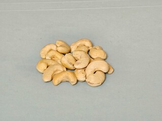 Fototapeta na wymiar Isolated roasted cashew nuts. Collection of roasted cashew nuts and halves, different angles isolated on white background with clipping path