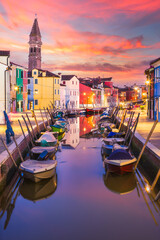 Fototapeta na wymiar Burano island canal during sunset, colorful houses and boats, Venice Italy Europe