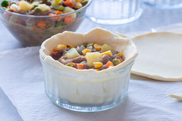 Making individual beef pot pies, step 4, put in filling, horizontal