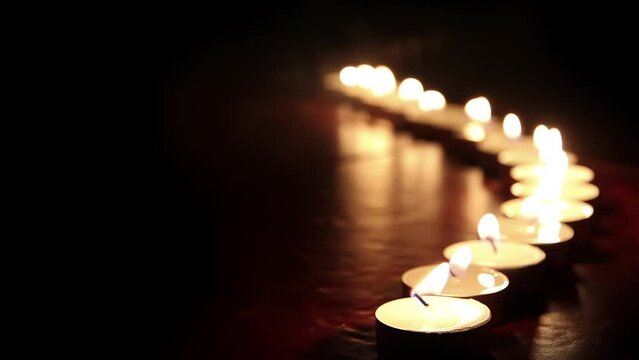 Candlelight. Little candles lined up light up one by one