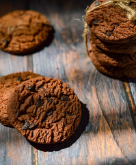Stack of chocolate cookies on wooden table.