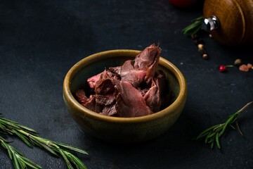 Pieces of dried beef fillet in a small ceramic bowl.