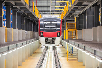 Electric train is parked in the electric train repair shop, Electric train engineer and technician...