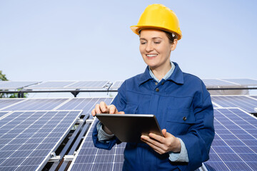 Woman with digital tablet on a background of mobile solar power station..