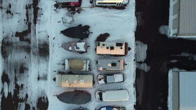 Drone view of camper, mobile home, and boat winter storage.