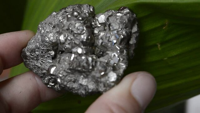 Pyrite mineral on green background
