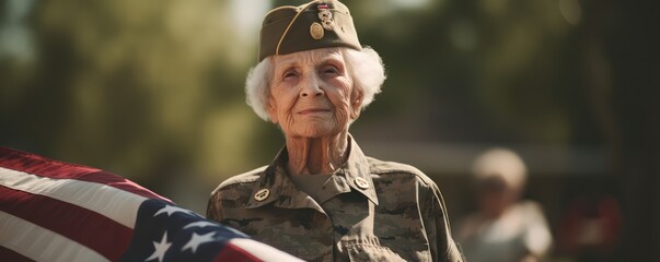 Elderly female veteran holds up an American flag for the memorial day,