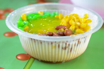 A traditional Malaysian dessert called Cendol is made from crushed ice cubes and a variety of sweets and fruits. This iced sweet dessert is served in a bowl as part of Malaysia's culinary tradition