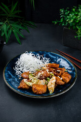 Asian lunch chicken fillet with apples, almonds, herbs and sauce.