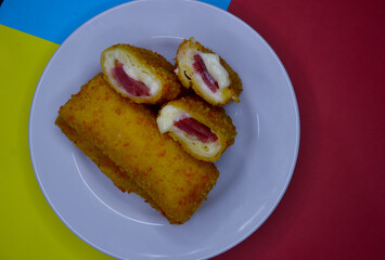 Risoles or risol mayo, stuffed with smoked meat  with mayonaise, on a  white plate.