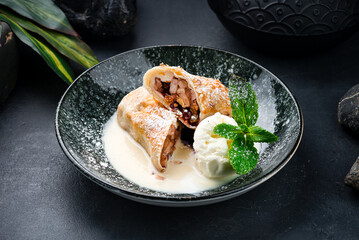 Sweet thin pancakes with apples, raisins, ice cream and mint.