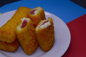Risoles or risol mayo, stuffed with smoked meat  with mayonaise, on a  white plate.