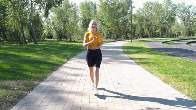 Senior woman running at summer park. Middle age woman health 