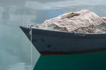 Grado, Italy - January 28th, 2024: a small fishing boat with fishing nets on the bow in the...