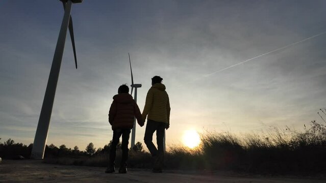 A nurturing mother and her curious son embrace a sustainable lifestyle, exploring the wonders of green technology, wind turbines, and environmental conservation. Together, they embark on a journey tow