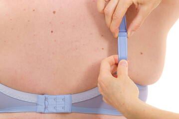 Bra fitter help plus size woman find perfect fit. Back view.