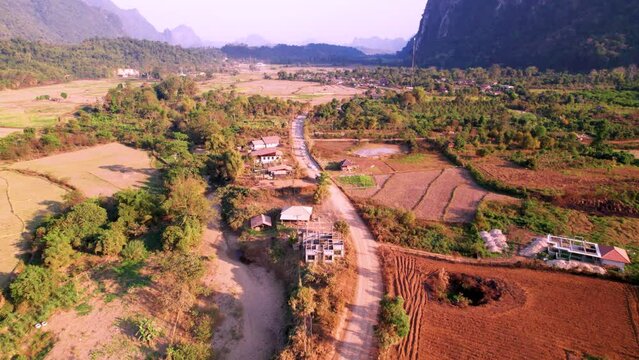 Village color&eacute;s le long d'une piste (route) dans la r&eacute;gion de Vang Vieng au Laos (vue aerienne)