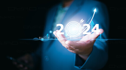 2024 business target goal finance technology and investment stock market trading concept. businessman holding virtual graph icon analysing forex or crypto currency trading graph financial data.