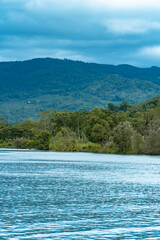 The downstream part of the river empties into the coast of Pacitan, Indonesia. The river downstream is wide and the water flow is calm and quite deep with a beautiful green hilly background