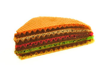 Waffle cake made from crispy colored waffle cakes with boiled condensed milk on a white background, close-up. Homemade baking.