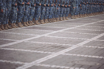 Military boots on the legs of soldiers in a row. Soldiers in marching formation during military...