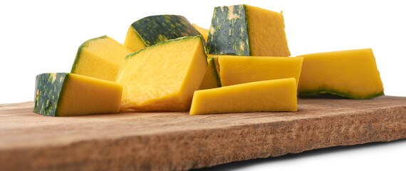 close-up of pumpkin slices on a wooden cutting board, sliced and vegetable pieces in cooking on kitchen table top, taken in selective focus and isolated on white background