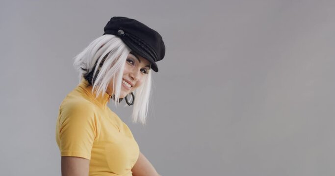 Happy, woman and cool fashion in studio, grey background and mockup with creative style. Vintage, clothes or portrait of model in retro outfit and hat with confidence, pride and unique aesthetic