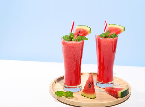 Fresh watermelon juice and watermelon slice on pastel color background. cooling beverage summer drink.