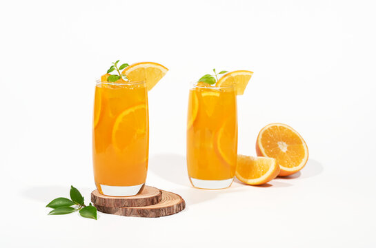 Glass of 100% Orange juice with orange slices fruits isolated on white background. cooling beverage summer drink