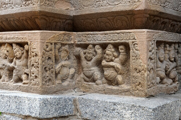 Carving of Dwarf-like Yakshas in Temple. Sandstone relief carving of ancient mythological sculptures on the wall of historic Kailasanathar temple in Kanchipuram.