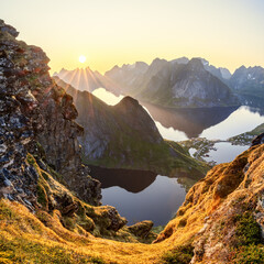 Heavenly light from the midnight sun over Reinebringen, casting a serene glow on the mossy landscape and distant mountains. Norweay, Lofoten Island (Square photo format)