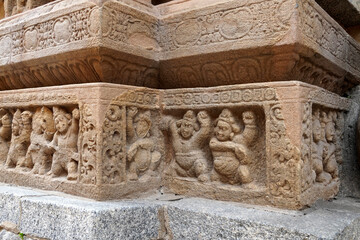 Carving of Dwarf-like Yakshas in Temple. Sandstone relief carving of ancient mythological sculptures on the wall of historic Kailasanathar temple in Kanchipuram.
