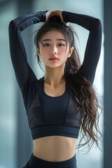 Fototapeta premium Asian beautiful girl in black clothes working out in a gym.