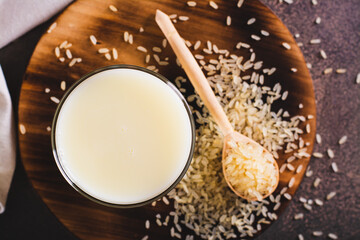 Close up of lactose-free rice milk in a glass and rice cereal on the table top view