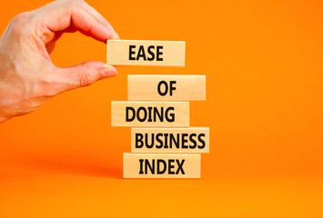 Ease of doing business index symbol. Concept words Ease of doing business index on wooden blocks. Beautiful orange table orange background. Business, ease of doing business index concept. Copy space.