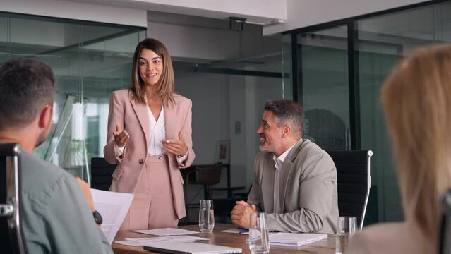 Happy professional board executive colleagues successful business team people collaborating having corporate teamwork discussion together at group office conference meeting boardroom table.