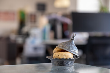 Eid sweets on desk inside working office during ramadan and eid