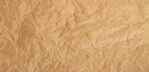 Crumpled yellow craft paper background.