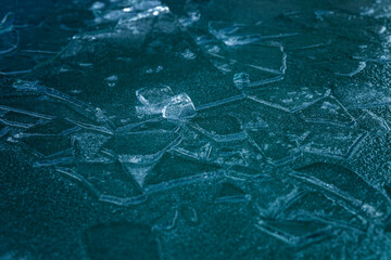Frozen water surface. Blue-green ice. Frost and low temperatures in the winter season. Close-up. Space for text. Background.