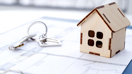 a house with keys on the contract of sale or lease of housing
