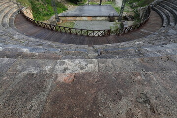 Semicircular stone stands overlooking the stage and orchestra of the Hellenistic ancient theatre...